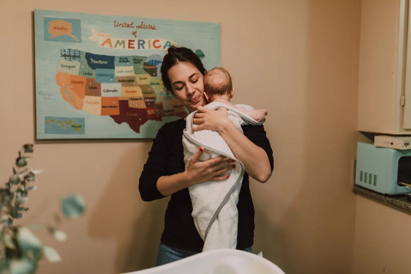 An illustrative moment of a caregiver holding a baby